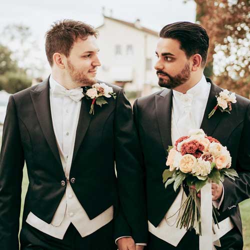 samesex wedding with the 2 spouses walking holding hands